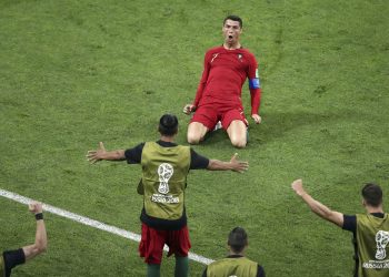Portugal's Cristiano Ronaldo kneels on the pitch as he celebrates after scoring his side's second goal against  Spain at Fisht Stadium in Sochi Friday
