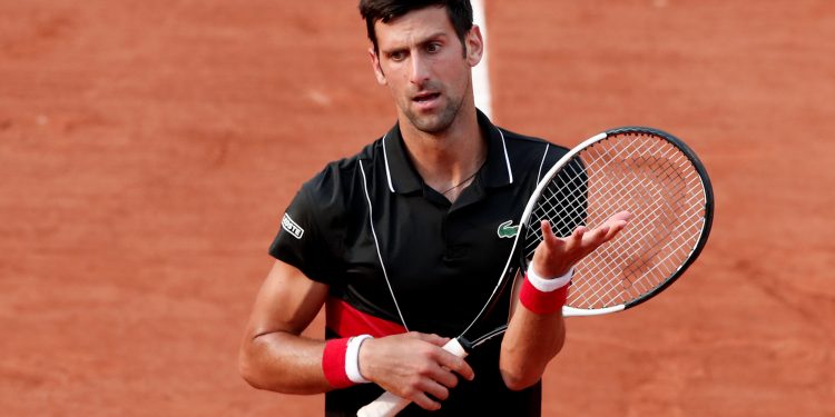 Novak Djokovic looks a dejected figure after his French Open quarterfinal defeat to unseeded Marco Cecchinato, Tuesday