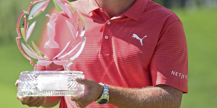 Bryson DeChambeau poses with the trophy after winning the Memorial Golf Tournament, Sunday