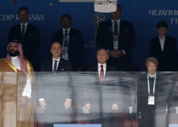 FIFA President Gianni Infantino (2nd from L) and Russian President Vladimir Putin (2nd from R) stand for the anthem before to the opening match at the Luzhniki stadium in Moscow, Thursday