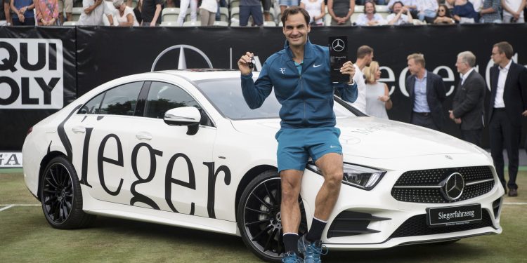 Roger Federer poses with the winner’s trophy at Stuttgart, Sunday