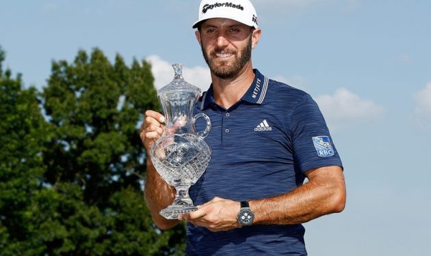 Dustin Johnson poses with his winners’ trophy at Memphis, Sunday