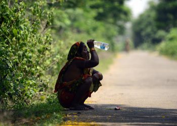 A woman on the outskirts of the city splashes water on her face to get respite from blistering heat
Pic: Bikash Nayak