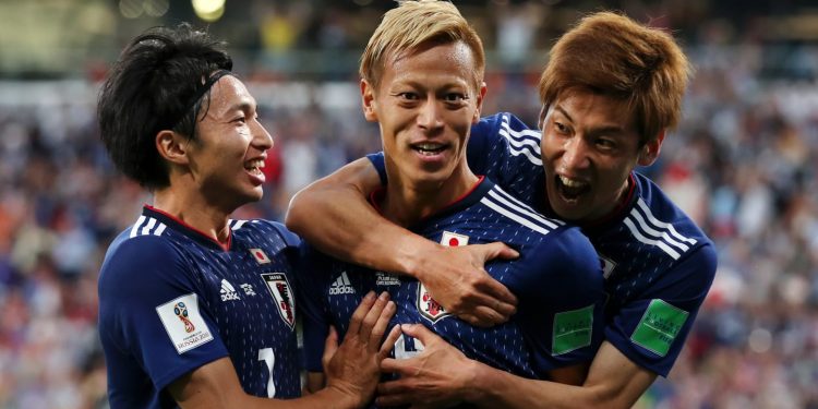 Keisuke Honda (C) is surrounded by his teammates after scoring Japan’s second goal against Senegal, Sunday