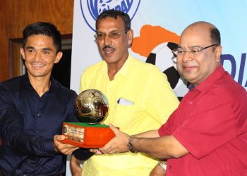AIFF vice-president Subrata Dutta hands the Indian player of the year award to Sunil Chhetri as former national player Subrata Bhattacharya looks on in Kolkata, Tuesday