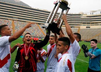 Unique competition: Peru players celebrate with the Prisoners’ World Cup trophy at Lima