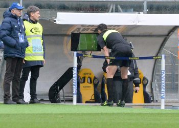 A referee looks at the TV screen closely for video assisting during a Serie A match in Italy