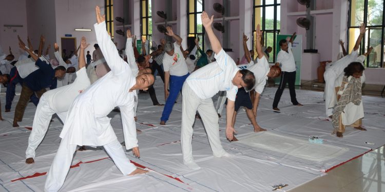 International Yoga Day being observed by East Coast Railway at Rail Vihar Community Hall in Bhubaneswar Thursday. Additional General Manager Rajeev Sharma led the team of ECoR to observe the Day