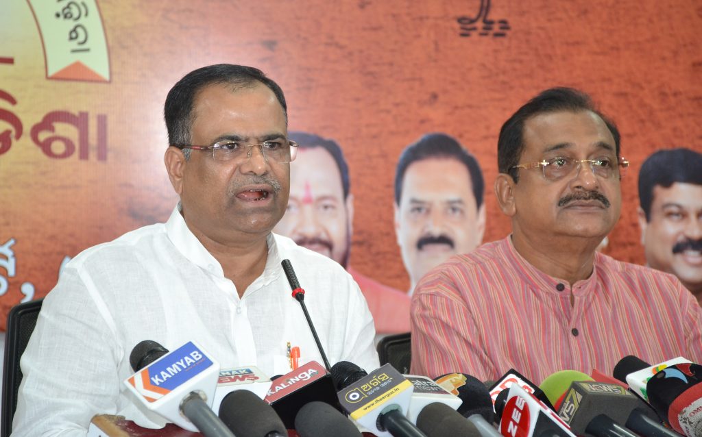 BJP spokesperson Pitambar Acharya (L) addresses the media in Bhubaneswar as party leader Samir Mohanty shares the dais.