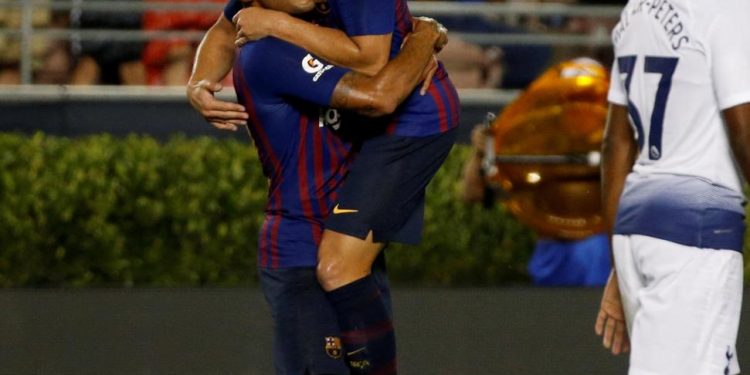 Arthur Melo (R) celebrates with teammate Rafinha after scoring on his maiden appearance for Barcelona against Spurs, Saturday