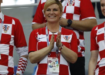 Croatian President Kolinda Grabar-Kitarovic (C) cheering the team on during one of the games