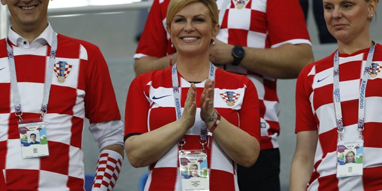 Croatian President Kolinda Grabar-Kitarovic (C) cheering the team on during one of the games