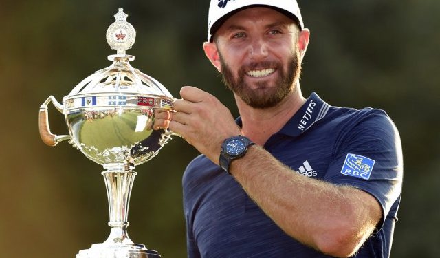 Dustin Johnson poses with the winner’s trophy in Toronto, Sunday