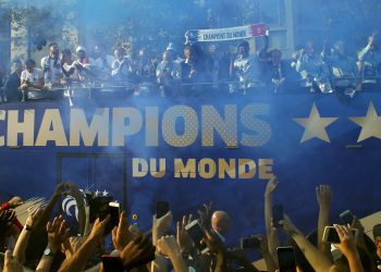 France's victorious World Cup team descends in a bus upon Paris' packed Champs-Elysees avenue upon their return from Russia