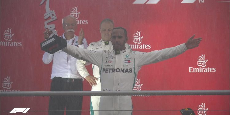 Lewis Hamilton celebrates with the German GP trophy, Sunday