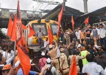 Thane: Maratha Kranti Morcha protesters stop a train during their statewide bandh, called for reservations in jobs and education, in Thane on Wednesday, July 25, 2018. (PTI Photo/Mitesh Bhuvad) (PTI7_25_2018_000062B) *** Local Caption ***