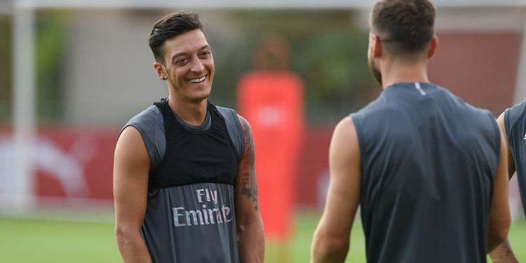 Mesut Ozil has something to laugh about during Arsenal's training session in Singapore