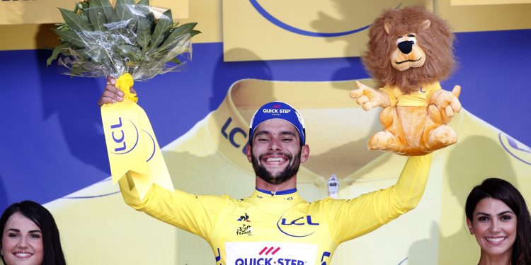 Stage winner and new overall leader Fernando Gaviria of Colombia celebrates on the podium after the first stage of the Tour de France cycling race over in Fontenay Le-Comte, France, Saturday