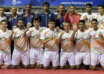 Indian Sepaktakraw team players along with the officials pose for a group photo after winning the first ever Asian Games bronze medal at Jakarta