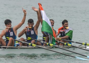 Indian rowing Men's team members Sawarn Singh, Bhokanal Dattu, Om Prakash and S Singh celebrate after the medal ceremony winning the gold medal during the Asian Games