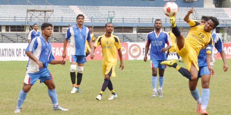 OGP and Chauliaganj Club players tussle for the ball during their match at the Barabati Stadium in Cuttack, Tuesday