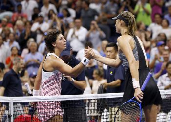 Maria Sharapova (in black) congratulates Carla Suarez Navarro after losing to the latter at the US Open, Monday 
