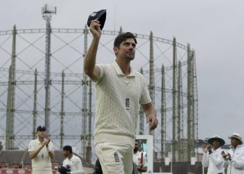 Alastair Cook raises his cap as he comes out of the field for one last time before retiring from test cricket at the Oval cricket ground