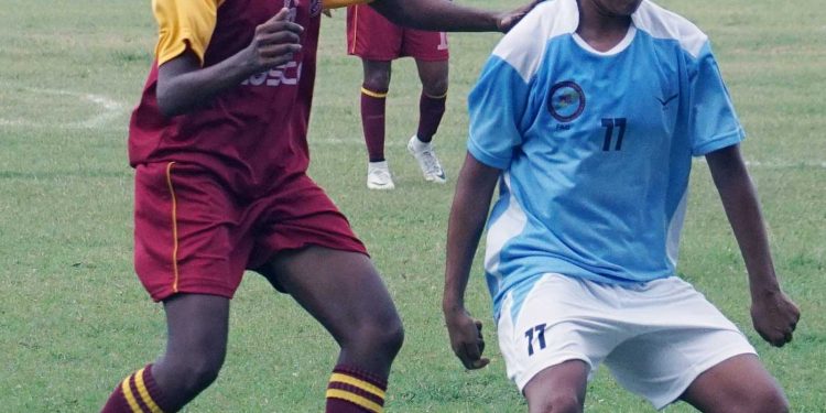 Anju Tamang (in blue) vies for the ball against West Bengal at Bidanasi Ground, Cuttack, Thursday