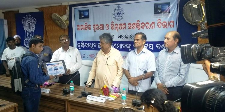 A visually-challenged student being given laptop in presence of SSEPD Minister Prafulla Samal (3rd from R) at National Career Service Centre for the Differently-Abled in Bhubaneswar, Wednesday