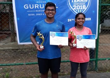 Ashish Kumar Parida (L) and Simran Neha Ekka pose with their certificates and trophies in Bhubaneswar, Sunday