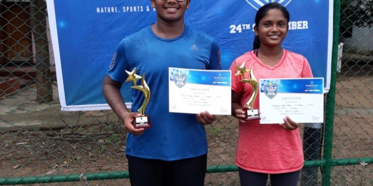 Ashish Kumar Parida (L) and Simran Neha Ekka pose with their certificates and trophies in Bhubaneswar, Sunday