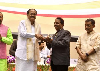 Om Prakash Mishra receives the award from the Vice-President in New Delhi.