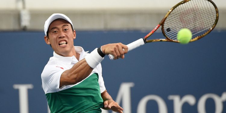 Kei Nishikori playing a shot against Yuichi Sugita in Tokyo, Monday.