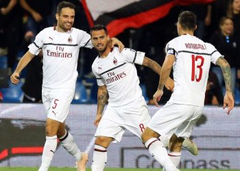 Teammates join in to congratulate Suso (C) after one of his goals against Sassoulo, Monday