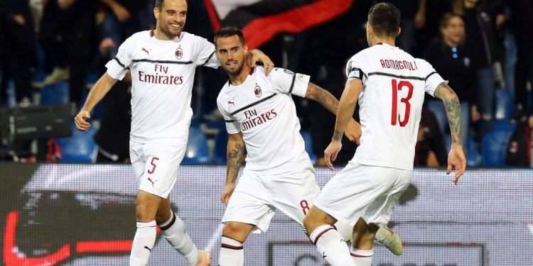 Teammates join in to congratulate Suso (C) after one of his goals against Sassoulo, Monday