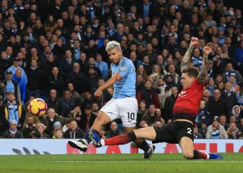 Sergio Aguero (10) strikes the ball past a sliding Man United defender straight into the opposition net (not in picture) at Etihad Stadium, Sunday