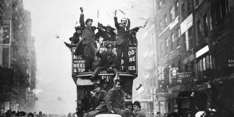 Crowds in London celebrate the end of hostilities in 1918