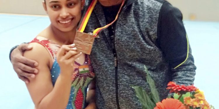 Indian gymnast Dipa Karmakar poses with her coach Bisweswar Nandi after wining bronze in Vault event at Artistic Gymnastic World Cup in Cottbus, Germany, Saturday