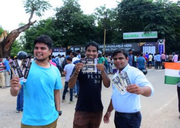 Fans show their tickets in front of a crowdie Gate No.9 of the Kalinga Stadium in Bhubaneswar, Monday 