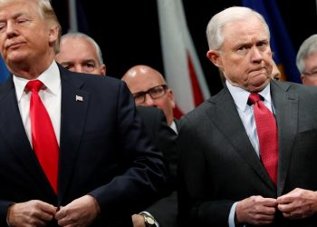 U.S. President Donald Trump and Attorney General Jeff Sessions button their coats as they stand for the national anthem at a graduation ceremony at the FBI Academy on the grounds of Marine Corps Base Quantico in Quantico, Virginia, U.S. December 15, 2017.  REUTERS/Jonathan Ernst/File Photo