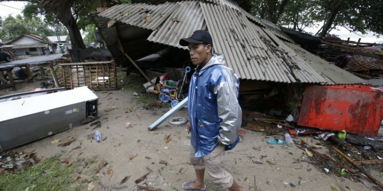 A man inspects his house damaged by a tsunami in Carita, Indonesia, Sunday, Dec. 23, 2018. The tsunami occurred after the eruption of a volcano around Indonesia's Sunda Strait during a busy holiday weekend, sending water crashing ashore and sweeping away hotels, hundreds of houses and people attending a beach concert. (AP)