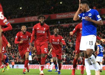 Divock Origi (C) leads Liverpool’s celebration after scoring last gasp winner as Everton’s Yerry Mina (blue-white) looks dejected at Anfield, Sunday