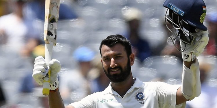 Cheteshwar celebrates scoring a century against Australia in Melbourne