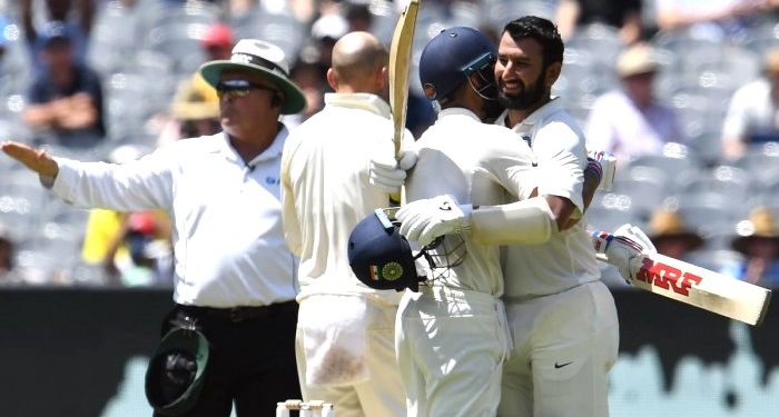 India's batsman Cheteshwar Pujara (R) celebrates reaching his century (100 runs) with teammate Virat Kohli during day two of the third cricket Test match between Australia and India in Melbourne on December 27, 2018. (AFP)