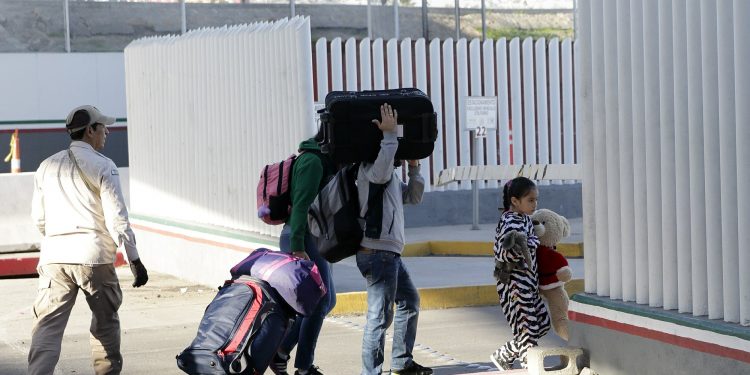 A family leaves to apply for asylum in the United States, at the border, Friday, Jan. 25, 2019, in Tijuana, Mexico. The Trump administration on Friday will start forcing some asylum seekers to wait in Mexico while their cases wind through U.S. courts, an official said, launching what could become one of the more significant changes to the immigration system in years. (AP)