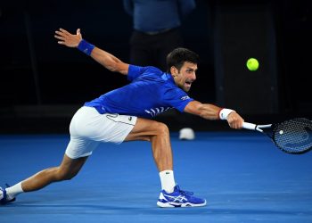 Novak Djokovic reaches for a shot during his match against Daniil Medvedev (not in pic) in Melbourne, Monday