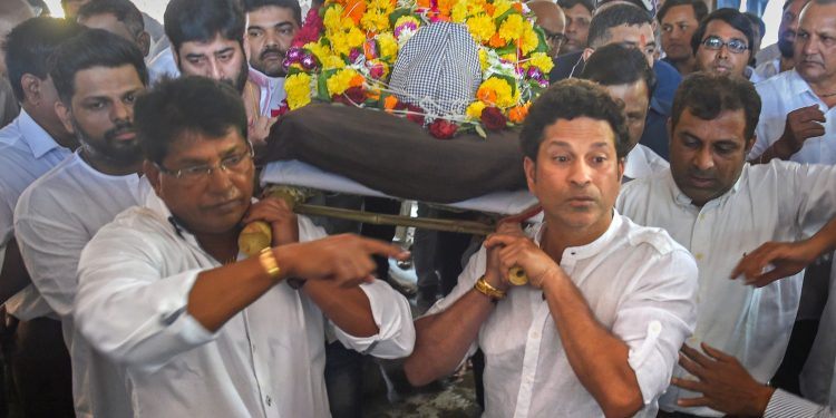 Former Indian cricketer Sachin Tendulkar attends the funeral procession of his coach Ramakant Achrekar, in Mumbai