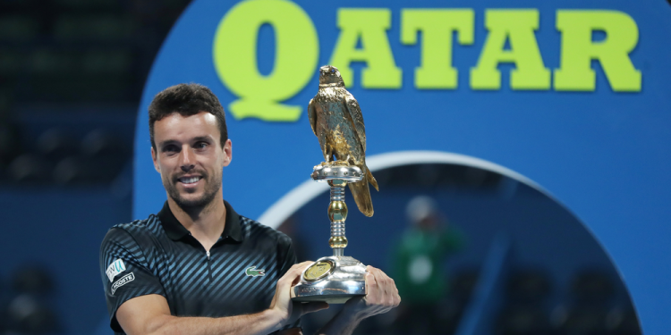 Roberto Bautista Agut poses with the winner’s trophy at Doha, Saturday