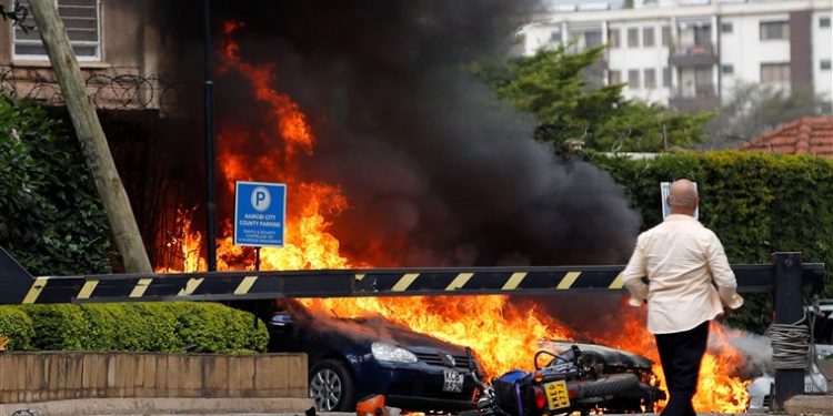 Cars on fire at the hotel compound in Nairobi where explosions and gunshots were heard, Tuesday