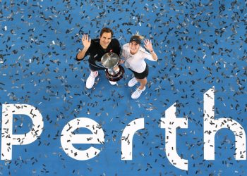 In an ariel view Roger Federer (L) and Belinda Bencic pose for the shutterbugs with the winner’s trophy at Perth Saturday